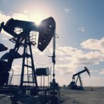 Oil pumpjacks in a Texas oil field under a clear blue sky
