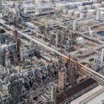 Aerial view of a large industrial complex with process units and storage tanks